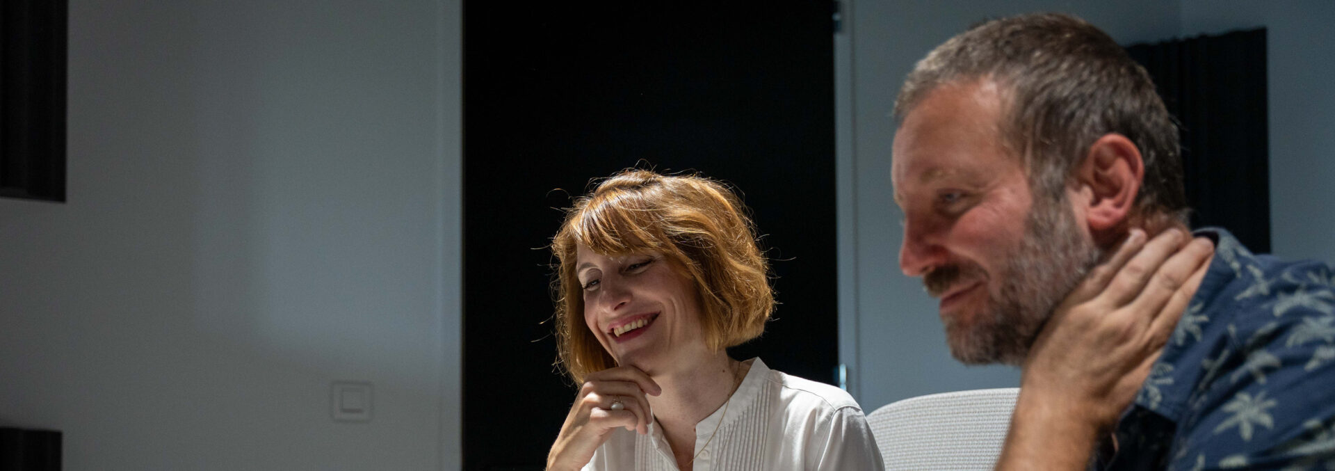 Deux professionnels travaillent ensemble sur un projet. Ils sourient.